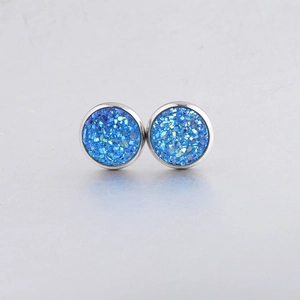 Detail view of 10mm round blue drusy stud earrings with polished silver metal edging