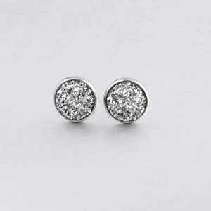 Detailed macro view of 10mm silver stainless steel stud earrings with sparkling texture