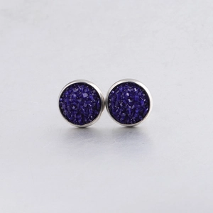 Macro detail of 10mm drusy stud earrings featuring dark blue crystals in silver frames