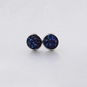 Macro shot of 10mm round blue drusy stud earrings with sparkling texture and silver edges