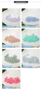 Macro shot of 4-10mm colorful iridescent gradient craft pearls in heart-shaped ceramic tray