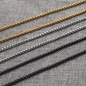 Detailed macro view of stainless steel Venetian box chains in gold, silver, and black finish