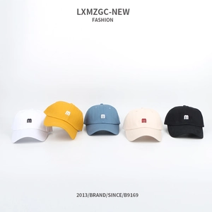 Flat lay of five cotton baseball caps with embroidered 'm' logo in various colors
