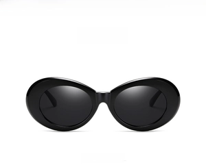 Detailed view of glossy black oval sunglasses featuring high-quality dark grey lenses