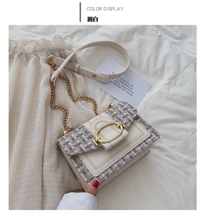 Detailed shot of an off-white tweed shoulder bag with gold chain and oval metal buckle