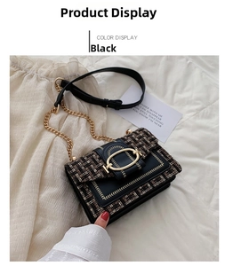 Detailed view of black tweed crossbody bag with golden buckle and chain strap on soft fabric