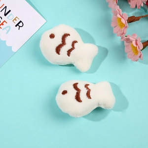 Cute white plush small fish pins with brown embroidery on a fresh light blue background
