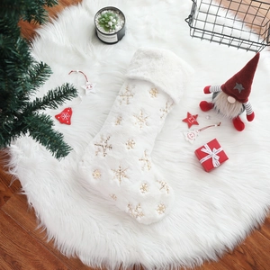 White faux fur Christmas stocking with gold snowflake embroidery for holiday home decor