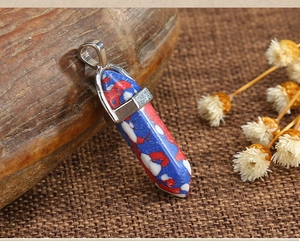 Close-up of hexagonal quartz pendants in multiple colors with metallic silver clasps