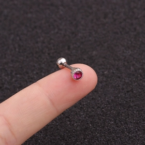 Detail shot of a silver stainless steel stud earring with a small round red zircon stone