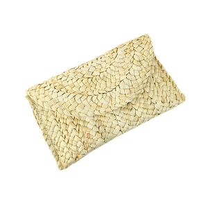 Handwoven corn husk straw envelope clutch bag in natural beige with flap closure