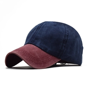Detail view of washed cotton baseball cap with navy crown and burgundy curved brim