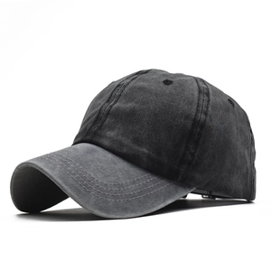 Detail of washed black cotton baseball cap showing vintage texture and stitching
