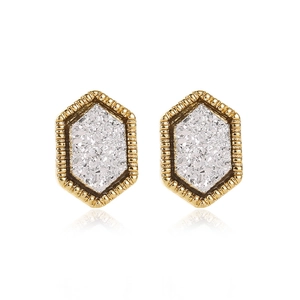 Close-up of hexagonal gold stud earrings featuring sparkling silver glitter stone inlay