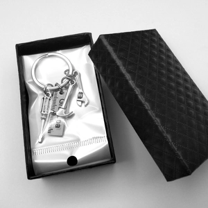 Detail view of mini hammer and wrench keychain tools in a black gift box for Grampa