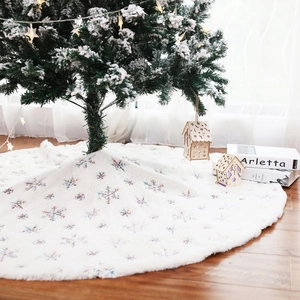 Plush white Christmas tree skirt with iridescent snowflake embroidery and warm lights