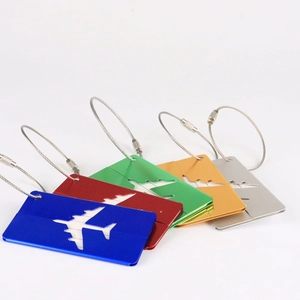 Detail of colorful metal airplane luggage tags with secure stainless steel wire loops