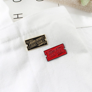 Vintage science fiction movie ticket enamel pins set in red and black on a white canvas bag