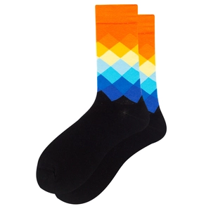 Macro view of colorful gradient diamond pattern on black cotton crew socks with soft texture