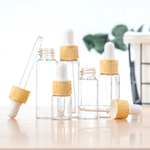 Clear glass dropper bottles with bamboo style caps in various sizes for essential oils
