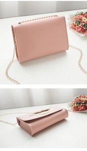 Detailed top and back view of small pink crossbody bag with gold lip-shaped clasp