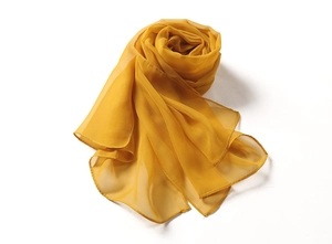 Detailed texture of golden lightweight chiffon scarf with elegant drapes and soft silk luster
