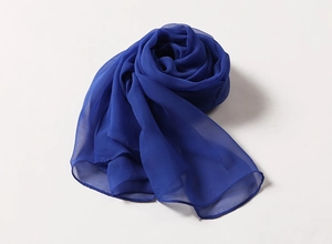 Close-up detail of lightweight dark blue georgette scarf fabric texture and drape