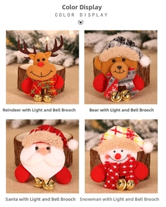 Detail of Christmas LED brooches with festive plush characters and golden metal bells