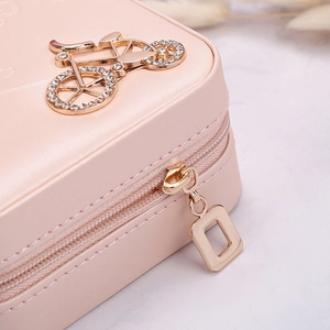 Pink portable jewelry box with golden bicycle diamond ornament and smooth zip closure