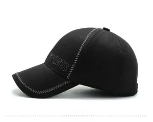 Detail of black winter baseball cap featuring white SPORTS embroidery and zig-zag stitching