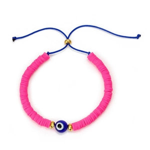 Detail of pink polymer clay bead bracelet with blue evil eye charm and woven string