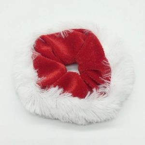 Detail of red velvet Christmas scrunchie featuring soft white faux fur trim and elastic band