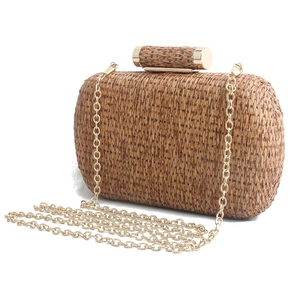 Handwoven straw clutch bag with golden cylindrical clasp and metal chain strap for women