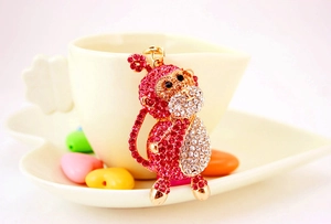Detail of creative monkey keychain featuring sparkling red and white crystal rhinestones