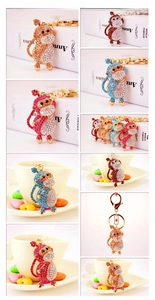 Close-up of crystal rhinestone monkey keychains in various colors with lobster clasps