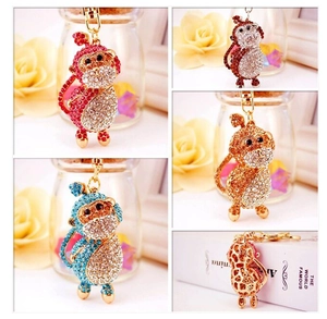 Detailed grid view of four colorful crystal-studded monkey zodiac keychains in various hues