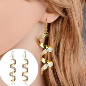 Detail of spiral drop earrings with gold and silver glitter finish on model and close-up