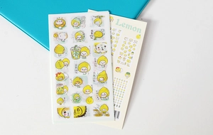 Detailed shot of yellow lemon washi stickers with Japanese text on a blue notebook