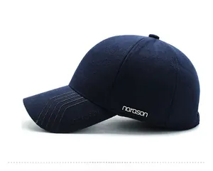 Side view of navy wool baseball cap for men featuring a metallic logo detail
