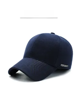 Detail view of thickened wool blend fabric and metal brand plate on navy winter cap