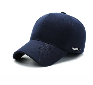 Detailed view of the dark blue wool blend cap with narason metal logo and fine stitching