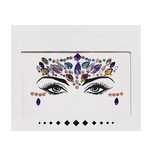 Macro detail of colorful holographic face crystal stickers in elegant white packaging