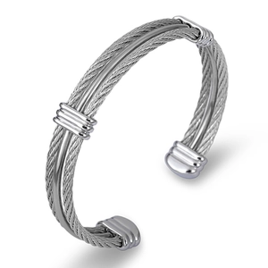 Detailed macro view of triple-strand silver braided steel cable bracelet with polished rings