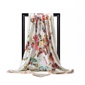 Detail of silk-satin scarf with butterfly print hanging on a minimal black frame
