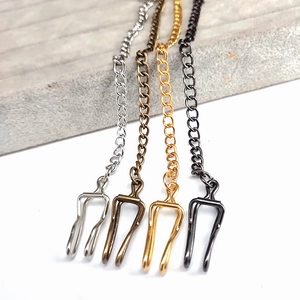Close-up of alloy lobster clasps with extension chains in four metallic plating colors