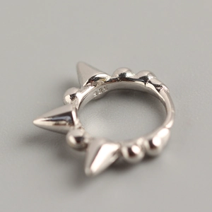 Punk S925 sterling silver hoop earring with spikes and beads on a grey background