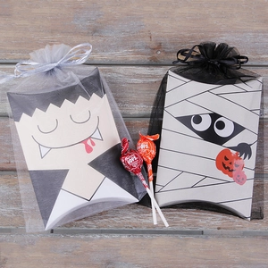 Halloween pillow boxes with vampire and mummy designs wrapped in orange organza bags