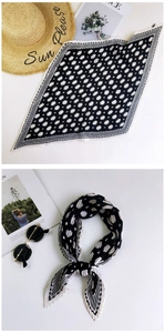 Detailed view of black and white polka dot pleated silk scarf with wavy edges