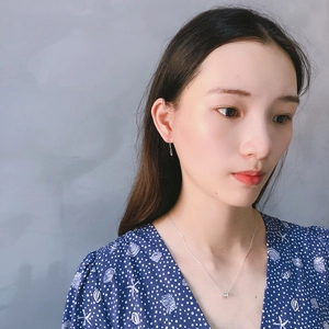 925 silver safety pin earrings and cylinder necklace set on female model in blue dress