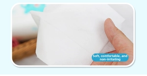 Close-up of soft white cotton disposable wipes showing fiber texture and flexibility